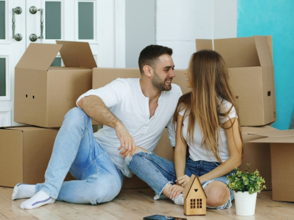 Happy couple sitting in their new home