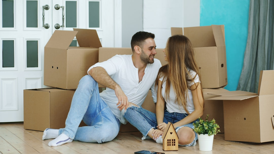 Happy couple sitting in their new home